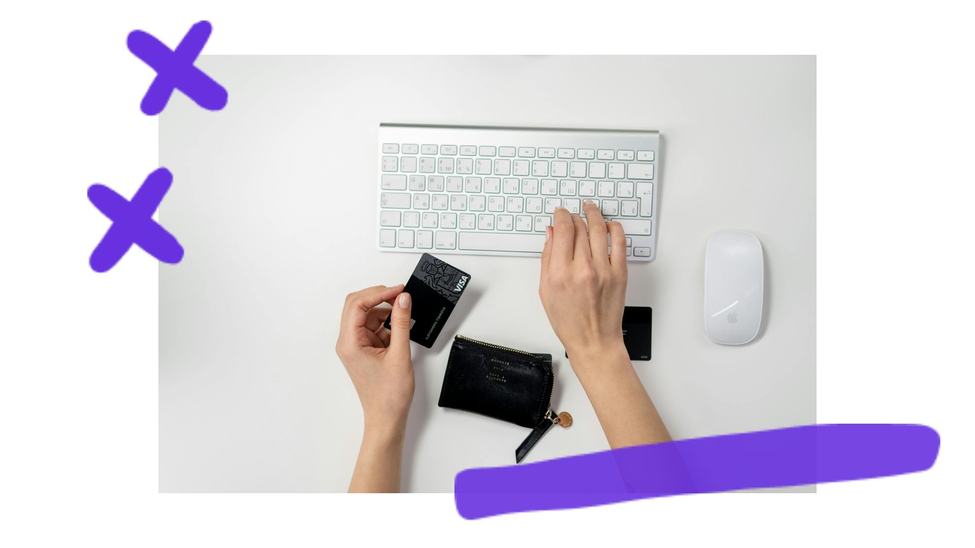 Hands on a white background; one hand is holding a black credit card; the other hand is typing on a keyboard.