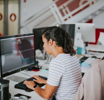 A developer working on a mobile application at their desk