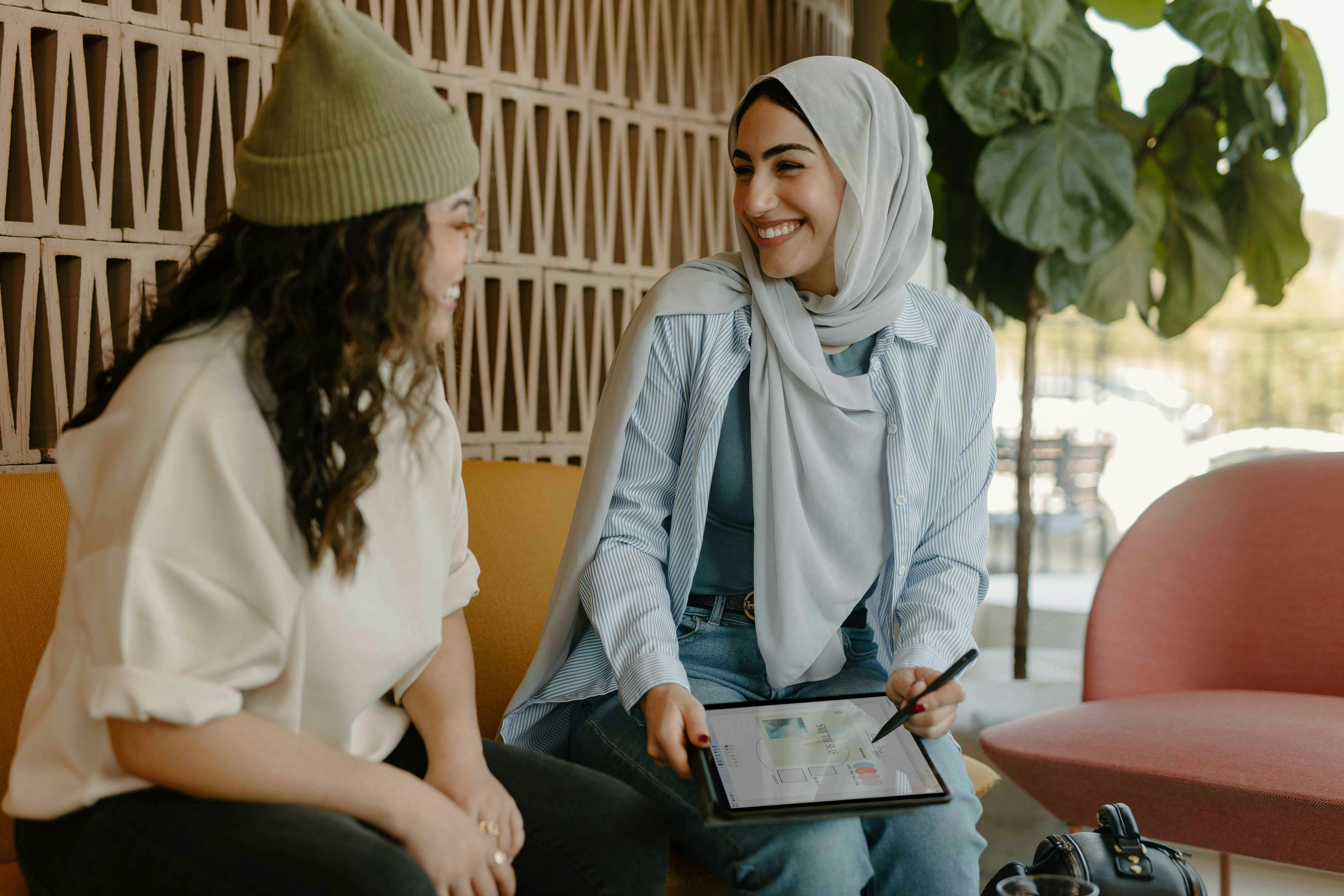 Two women chatting in a professional context.